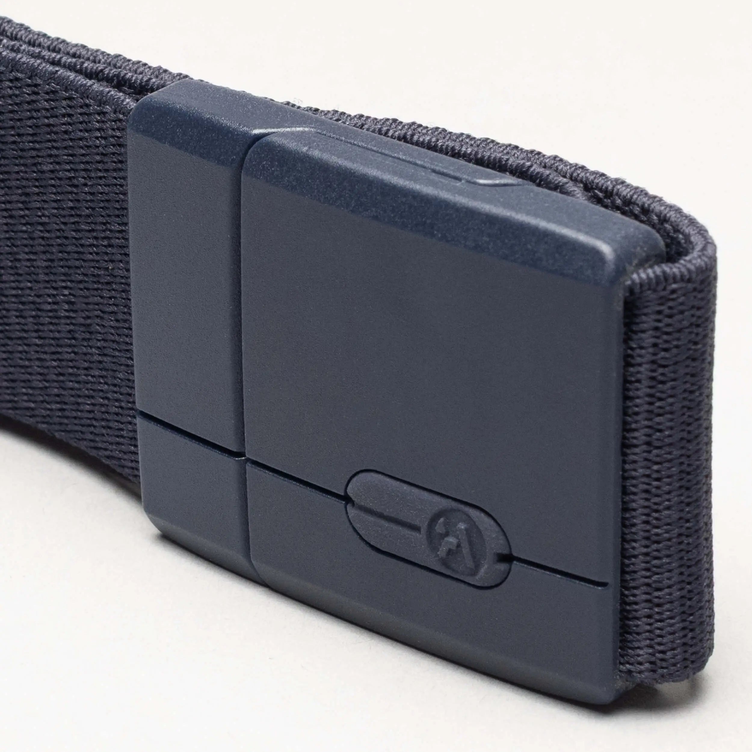 Navy blue belt with a plastic buckle on a light gray background | XSports