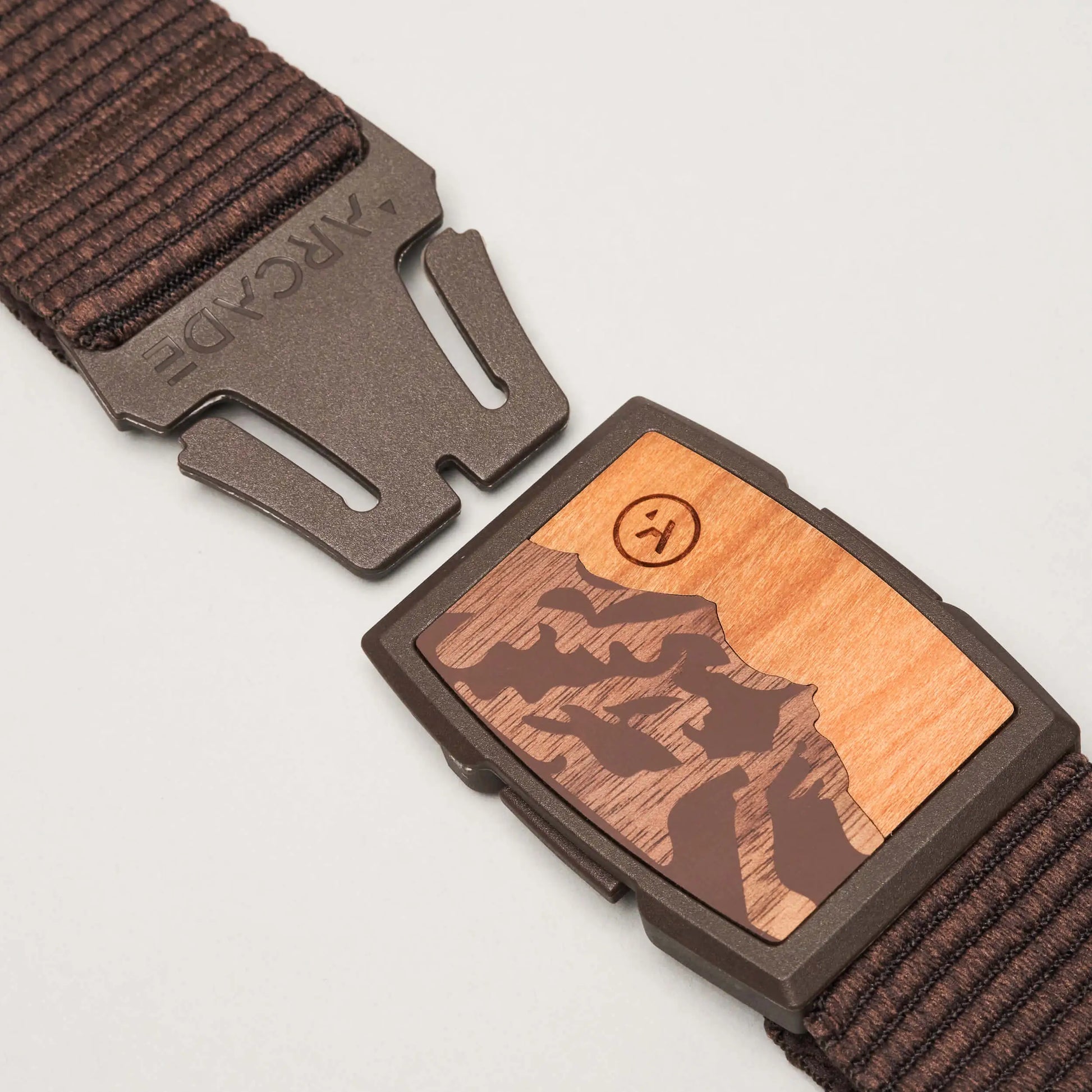 Brown belt with wooden buckle on a light gray background | SXSports